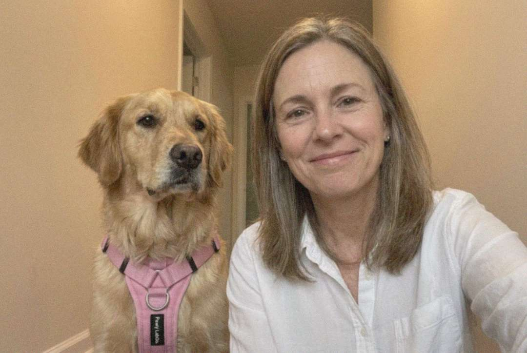 The same selfie setup — Luna now wearing the pink Pawly harness